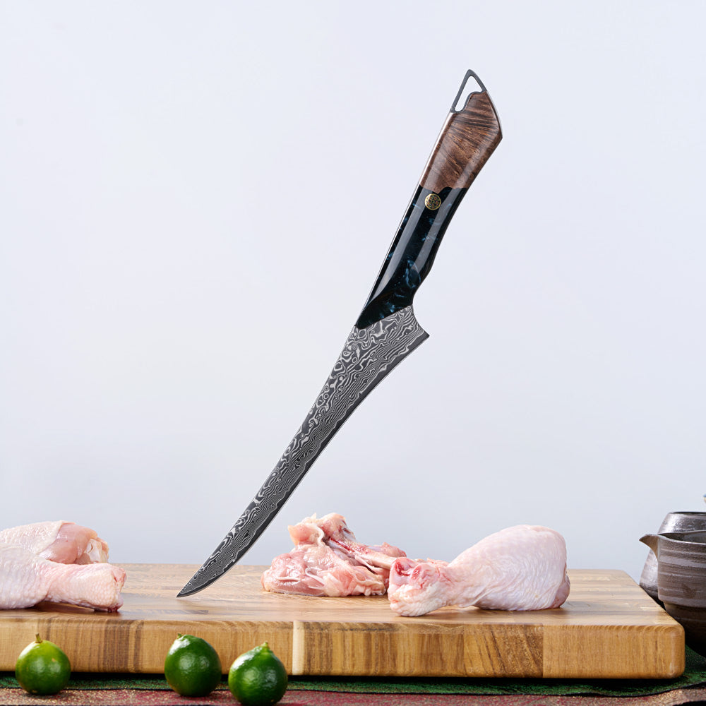Decorative knife with a wooden handle on a cutting board with raw meat and limes.