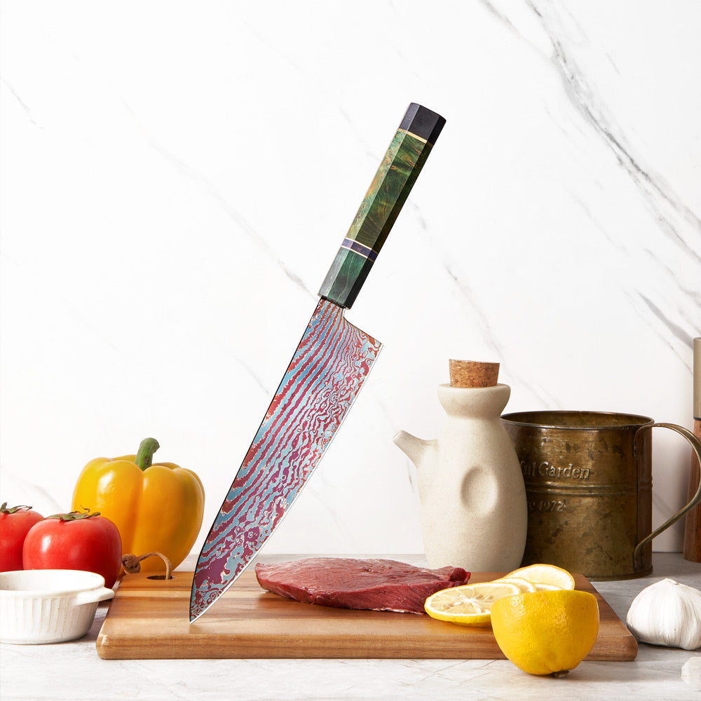 Chef's knife with a decorative blade on a kitchen counter with vegetables and a cutting board.