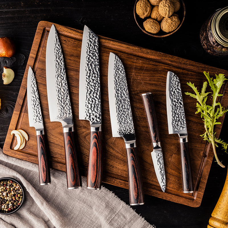 Set of Hikari professional knives on a wooden cutting board with a dark background